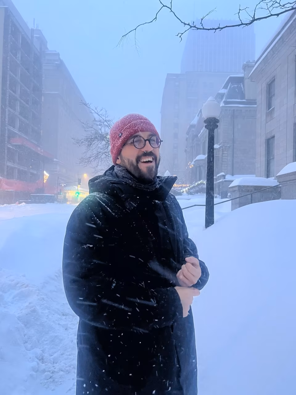 A teammate out in a snowy city street during a winter conference trip.